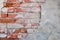 Red brick wall half covered with gray cement a lot of copyspace