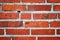 Red brick wall with hole as a background
