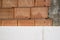 Red brick wall and nsulation of white polystyrene