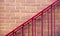 Red brick wall texture and railing to go upstairs