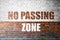 Red Brick wall texture with a word No Passing Zone