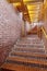 Red brick walls and staircase with wooden roof interior corridor