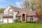 A red brick and white vinyl suburban home.