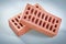 Red bricks on concrete background bricklaying concept