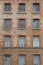 Red bricks and old peeling windows of an old industrial building