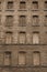 Red bricks and old peeling windows of an old industrial building