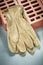 Red bricks protective gloves on concrete background construction