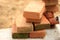 Red bricks stacked at a construction site, close-up.