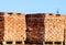 Red bricks stacked into cubes. Warehouse bricks. Storage brickworks products