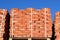 Red bricks stacked into cubes. Warehouse bricks. Storage brickworks products