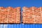 Red bricks stacked into cubes. Warehouse bricks. Storage brickworks products