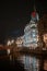 Red bridge, building, spire, river, night city, reflection in the water.