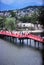 Red bridge leads to Japanese mountain village