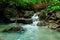 Red Bridge over waterfall