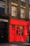Red bright old shop on a bricks house. London