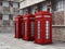 Red British phone booths in the street. 3D illustration