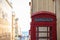 Red British telephone booth. Empty, vintage, peeled phone box in Valletta, Malta. Copyspace, close up view, blurred town backgroun