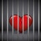 Red broken heart in a jail on dark background