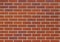 Red brown brick wall texture in a traditional running bond pattern