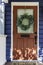 Red-brown front door in dark blue wall