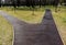 Red brown granulare rubber running mat path in forest and park setting