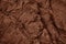 Red brown rock texture. Cracked layered mountain surface. Close-up. Grungy stone background