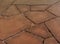 Red brown sand stone paving. smooth flat sandy texture & grit and uneven joints.