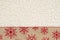 Red and brown snowflake border winter background on beige sherpa material