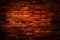 Red brown vintage grunge brick wall texture background with light shading on wall.