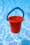 Red bucket with blue handle underwater