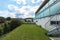 Red building exterior with large garden and glass parapet