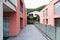 Red building exterior with large terrace and glass parapet