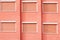 Red Building Facade with Six Closed Windows Shutters