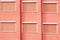 Red Building Facade with Six Closed Windows Shutters