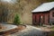 A red building sits alongside a railroad track