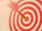 Red bullseye dart arrow hitting target center of dartboard. Concept of success, target, goal, achievement.