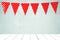 Red bunting party flag with heart shape pattern hanging over green wall and perspective white wood background