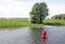 Red buoy beacon in lake shore water mark for ships