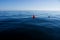 Red buoy on blue sea