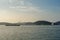 Red buoy floating in the sea with seascape and landsacpe in background. The ship traveling along the ocean with cityscape and