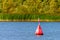 Red buoy on the Volga river for the safety and security of the boats travelling on the water