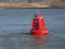Red buoy on the waal river in the Netherlands