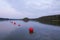 Red buoys secure swimming area on the lake at sunset