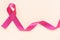Red burgundy ribbon bow curl on isolated pastel beige background with copy space, symbol of Multiple Myeloma or Plasma cell cancer