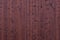 Red burgundy wooden texture background. Large wall surface. Vertical wooden boards with nails.
