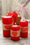 Red burning candles over wood background. Valentine, close up