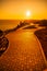 A red burning sunset with the silhouett of a cliff over the sea in park