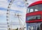 Red bus crossing the Westminster bridge at London city and the huge ferris wheel London Eye