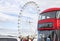 Red bus crossing the Westminster bridge at London city and the huge ferris wheel London Eye