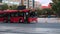 Red bus driving going around the Republic Square